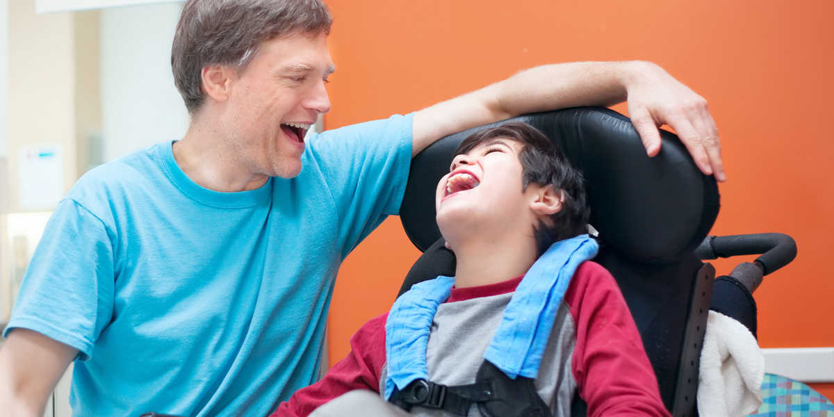 A special needs father and son smiling
