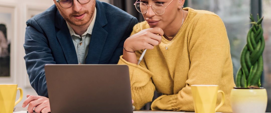 Two business people looking at a laptop