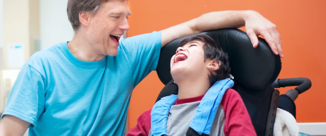 A special needs father and son smiling